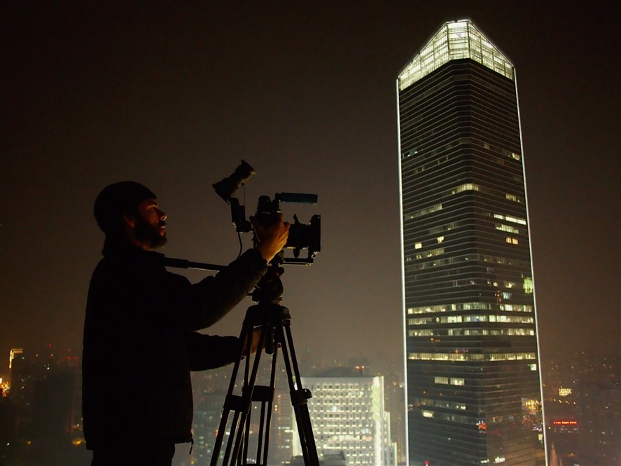 Shanghai filming crew at night with city lights in the background